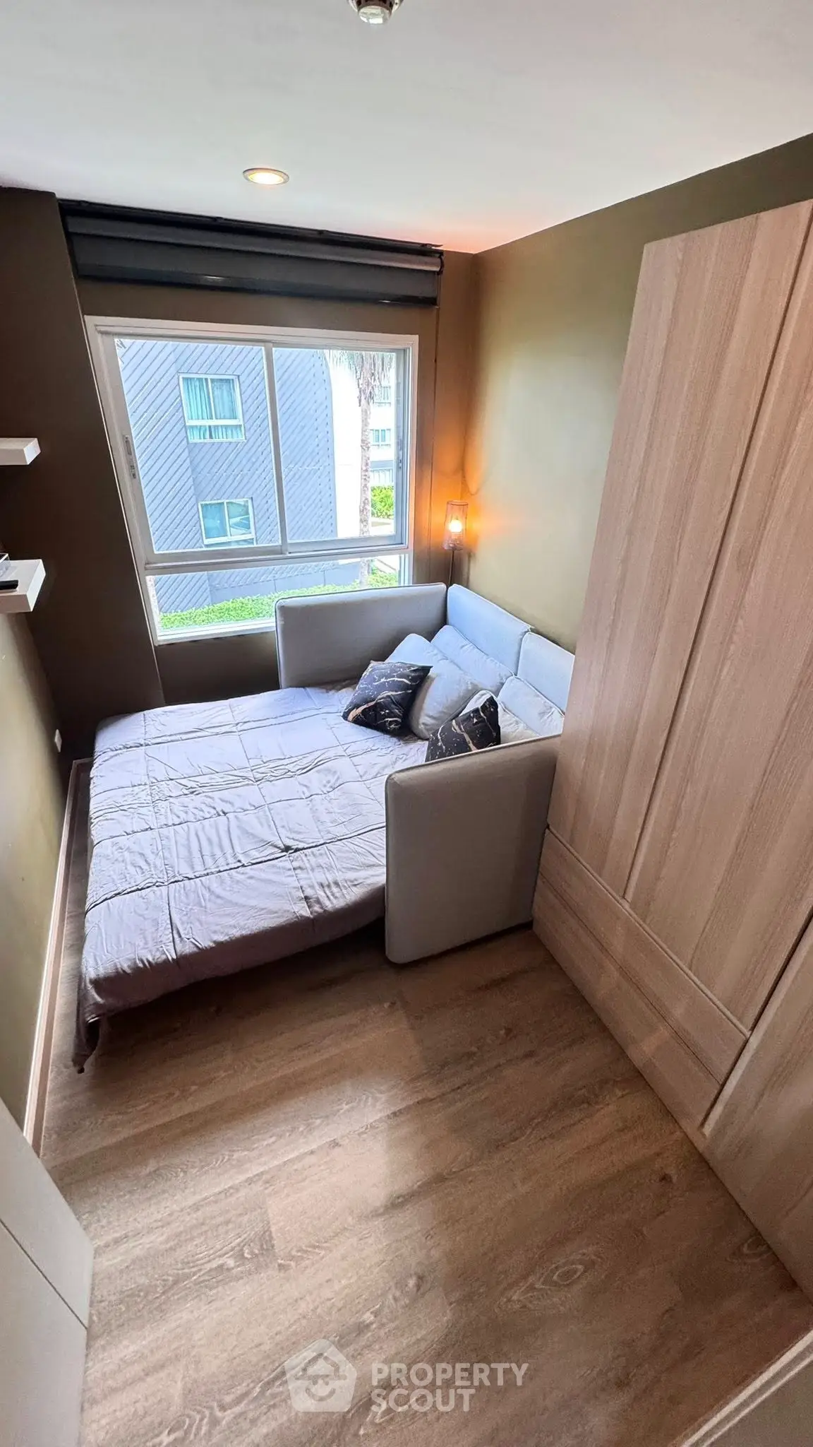 Cozy bedroom with modern decor and large window view