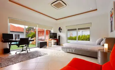 Spacious bedroom with garden view and modern furnishings