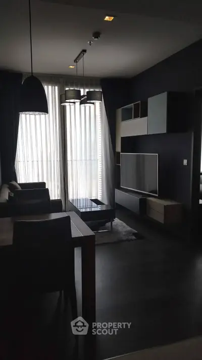 Modern living room with sleek furniture and large windows in a stylish apartment.