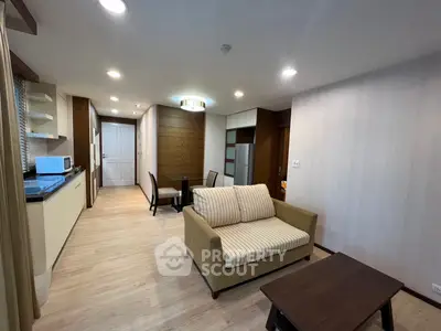 Modern living room with cozy sofa and open kitchen layout