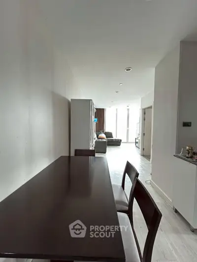 Spacious modern living area with dining table and cozy seating, perfect for entertaining.