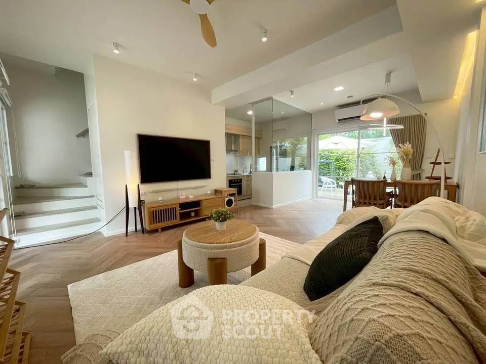 Spacious modern living room with cozy decor and open kitchen layout