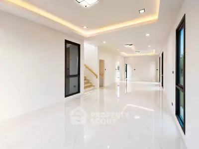 Spacious modern interior with glossy floors and ambient lighting, perfect for luxury living.