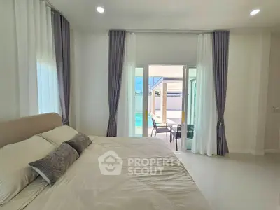 Luxurious bedroom with pool view and elegant decor