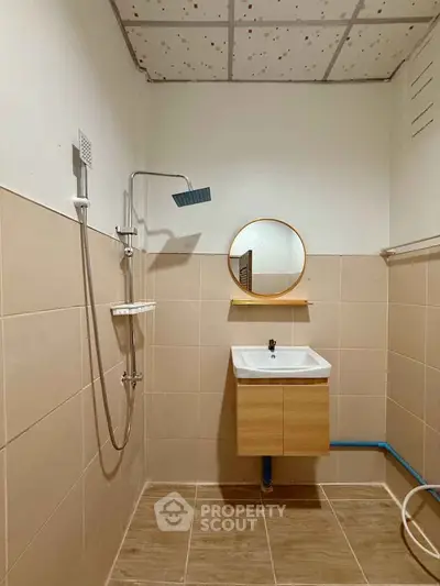 Modern bathroom with sleek shower and stylish vanity in a minimalist design.