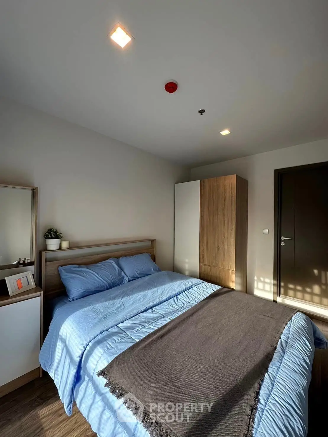 Cozy bedroom with modern decor and ample natural light