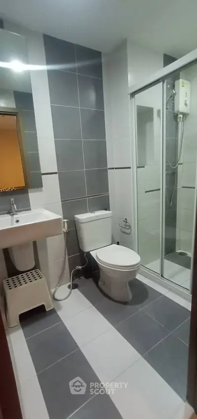 Modern bathroom with sleek tiles and glass shower enclosure
