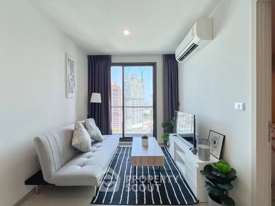 Modern living room with city view, stylish decor, and air conditioning in a high-rise apartment.