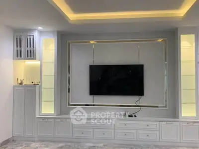 Modern living room with built-in TV unit and ambient lighting