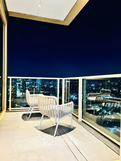 Luxurious high-rise balcony with stunning city skyline view at night