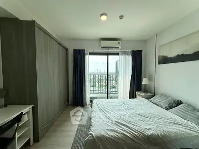 Spacious bedroom with balcony view in modern apartment