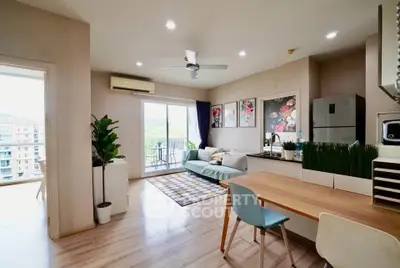 Modern living room with balcony, stylish decor, and open layout in a bright apartment.