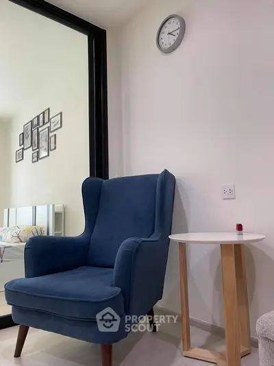 Cozy reading nook with blue armchair and modern decor in stylish apartment.