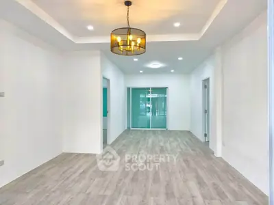 Spacious modern living room with elegant lighting and wooden flooring