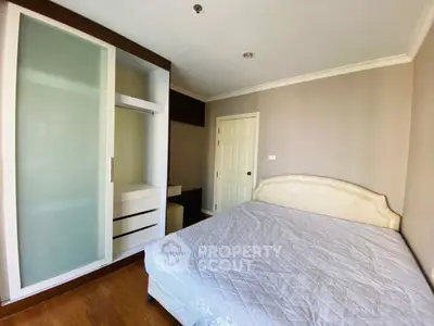 Spacious bedroom with modern wardrobe and cozy bed in elegant apartment