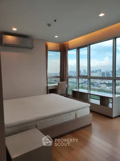 Spacious bedroom with panoramic city view and modern furnishings