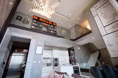 Luxurious modern living room with high ceiling and elegant chandelier