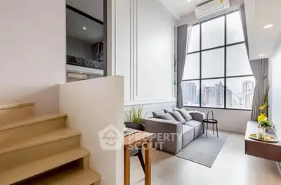 Modern loft-style living room with large windows and city view.