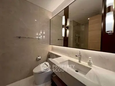 Luxurious modern bathroom with elegant marble finishes and sleek fixtures.