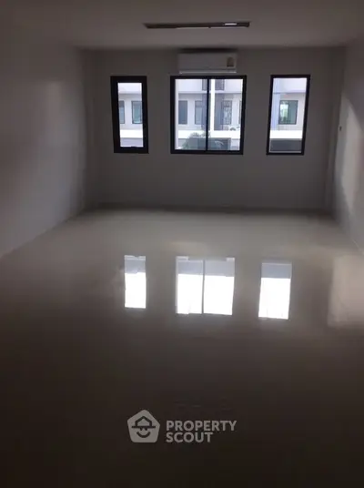 Spacious empty room with large windows and glossy tiled floor, perfect for customization.