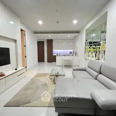 Modern living room with sleek furniture and open kitchen layout