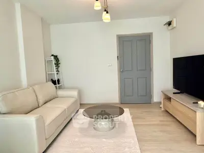 Modern living room with cozy beige sofa and sleek TV setup