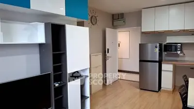 Modern apartment interior with open kitchen and stylish storage solutions.