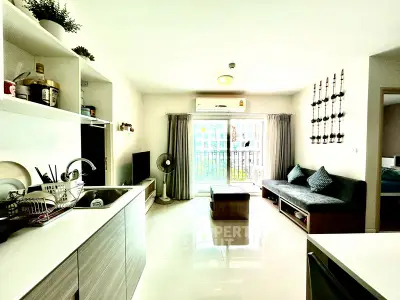 Modern living room with open kitchen and balcony view