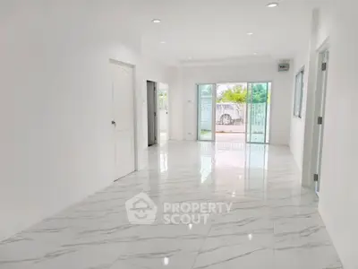 Spacious modern living room with marble flooring and large windows