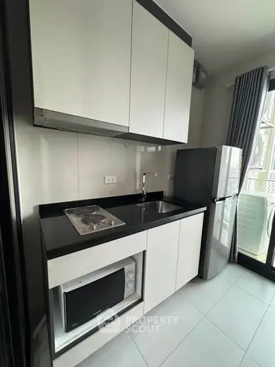 Modern compact kitchen with sleek cabinets and stainless steel appliances