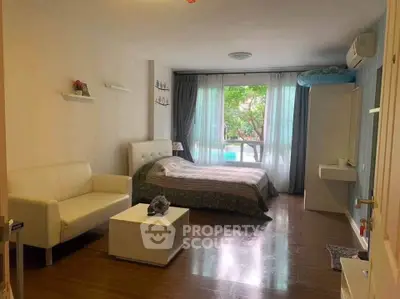 Cozy bedroom with modern decor and large window view