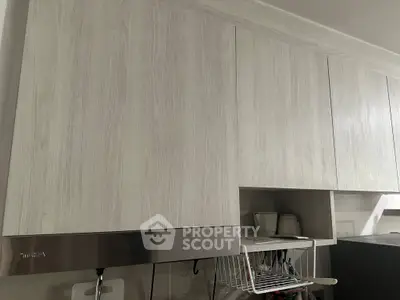 Modern kitchen with sleek cabinets and stainless steel range hood