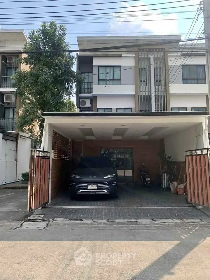 Modern townhouse with covered parking and sleek exterior design.
