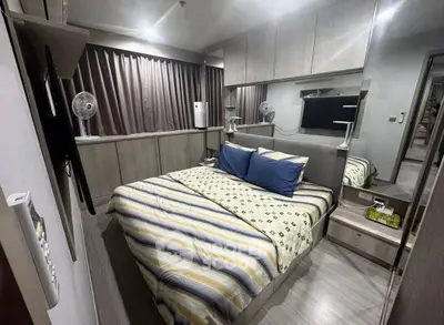 Cozy modern bedroom with stylish decor and ample storage space.