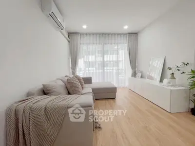 Modern living room with cozy sofa and natural light