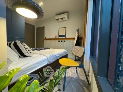 Modern bedroom with stylish decor and large window view