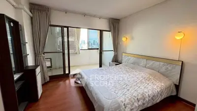 Spacious bedroom with balcony and city view in modern apartment
