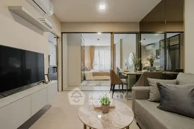 Modern living room with stylish decor and open view to bedroom