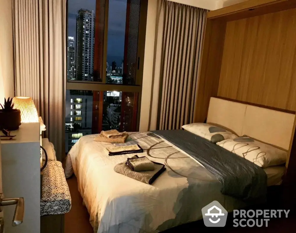 Cozy bedroom with city view, modern decor, and ambient lighting