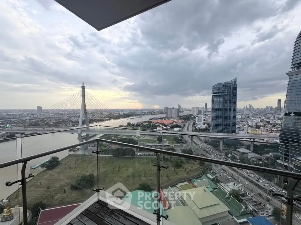 Stunning cityscape view from a high-rise balcony overlooking a river and modern skyline.