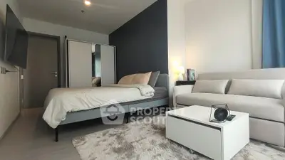 Modern bedroom with cozy sofa and stylish decor in a contemporary apartment.