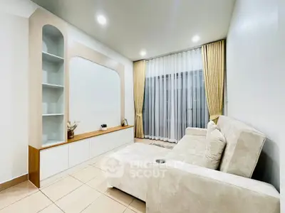 Modern living room with elegant beige sofa and stylish shelving unit