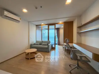 Spacious modern living room with wooden flooring and stylish furniture in a contemporary apartment.