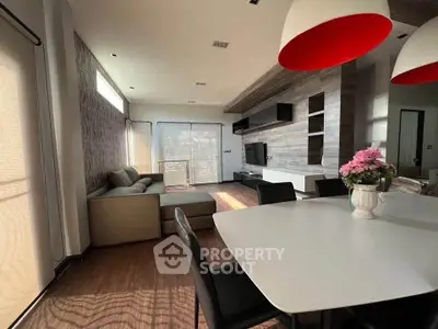 Modern living room with stylish decor, large windows, and elegant dining area, perfect for family gatherings.