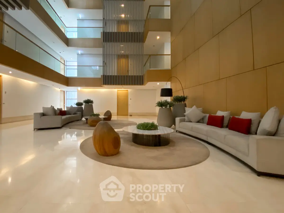 Luxurious modern lobby with elegant seating and stylish decor in a high-end residential building.