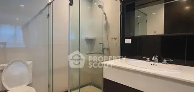 Modern bathroom with glass shower and sleek vanity