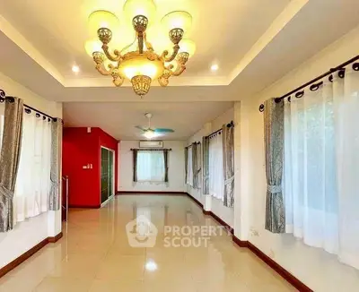 Spacious living room with elegant chandelier and large windows