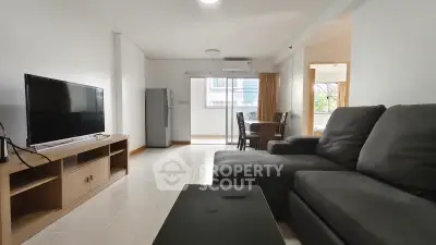 Spacious living room with modern furniture and natural light, perfect for relaxation and entertainment.