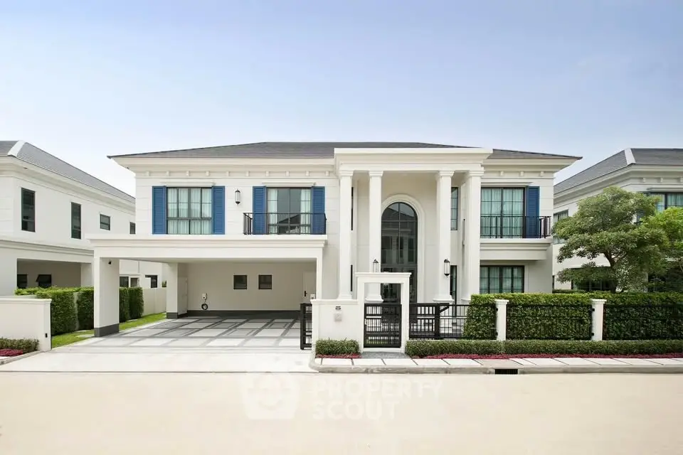 Luxurious modern villa with grand entrance and spacious driveway in a serene neighborhood.