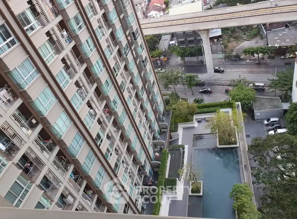 Modern high-rise building with pool and city view from balcony